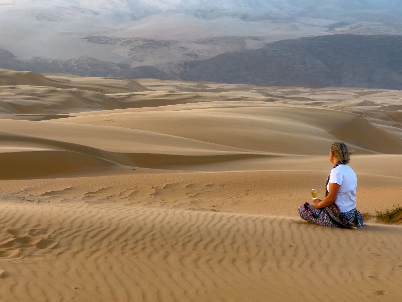 Kerry sitting on desert in Namibia 2023